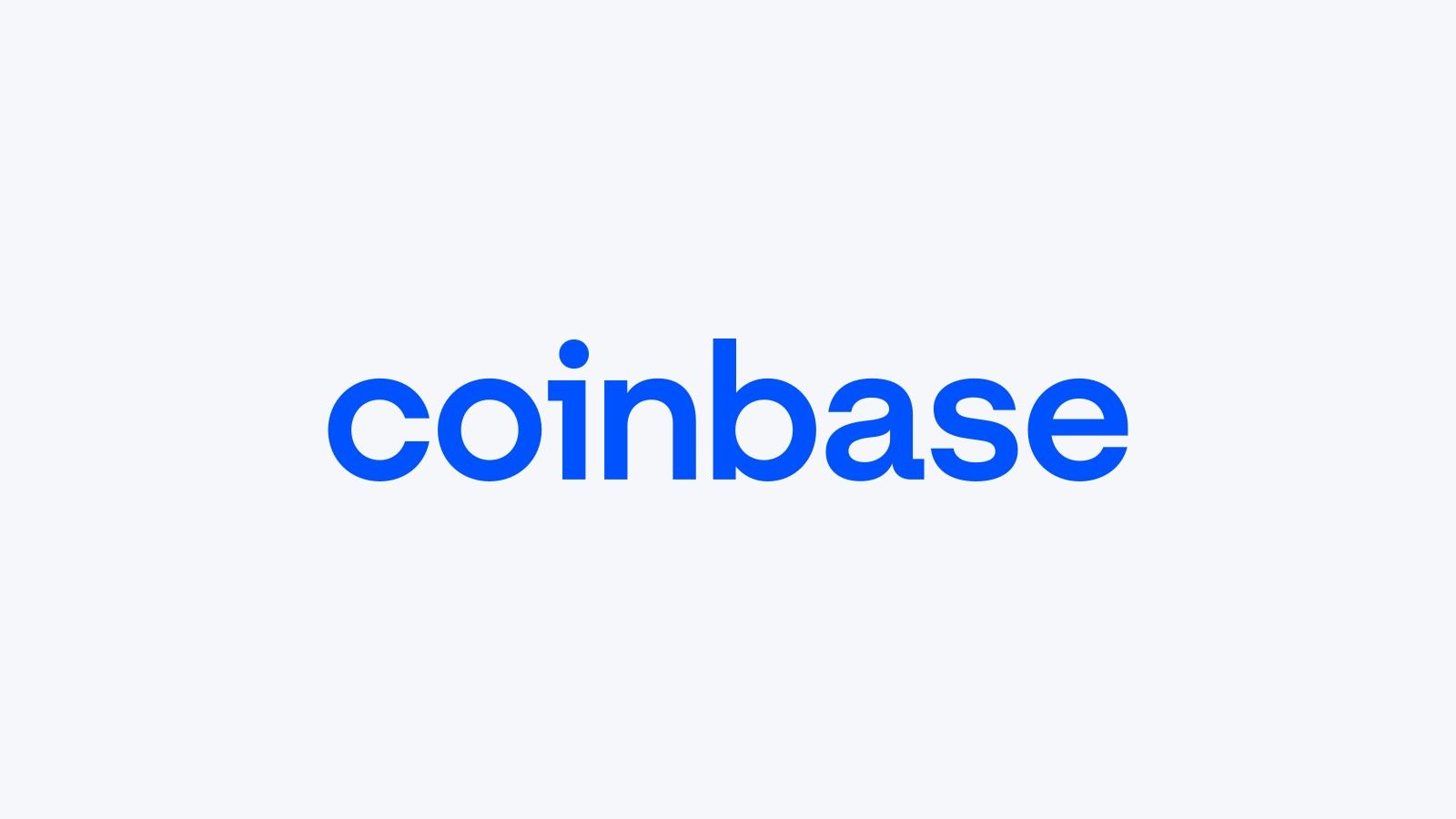 The Coinbase logo, a blue wordmark, on a pale grey background
